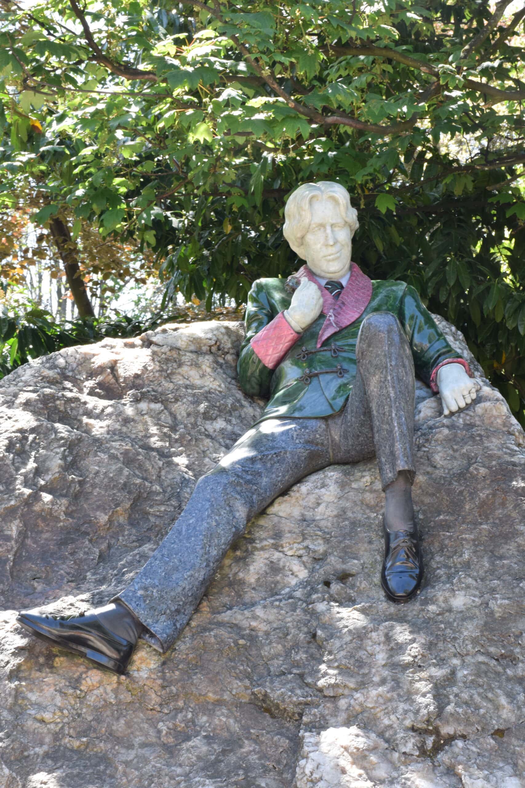 Statue of Oscar Wilde lounging on a boulder in Merrion Square in Dublin.